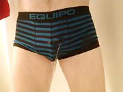 Wetting in blue and black Equipo trunks, standing