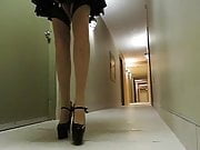 Sissy Ray in hotel corridor wearing maids uniform