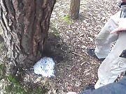 two friends pissing together a big puddle under the tree