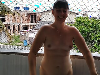 Wife works nude on balcony teasing her cuckold husband