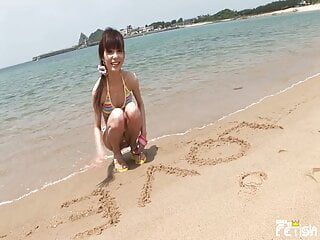 Japanese Chick Enjoys video: Skinny Japanese chick enjoys having a photoshoot on a beach