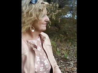 Caryl walking (flashing) in the woods