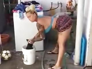 sexy lady dancing while washing clothes