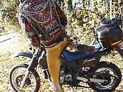 Punkbiker in gold leggings on his Suzuki DR650 Dakar