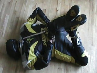 Yellow and black bikerslave is hogcuffed...