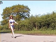 Zoe exhibitionist in her blue bikini outdoors on the road