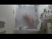 taking a shower through clear curtain